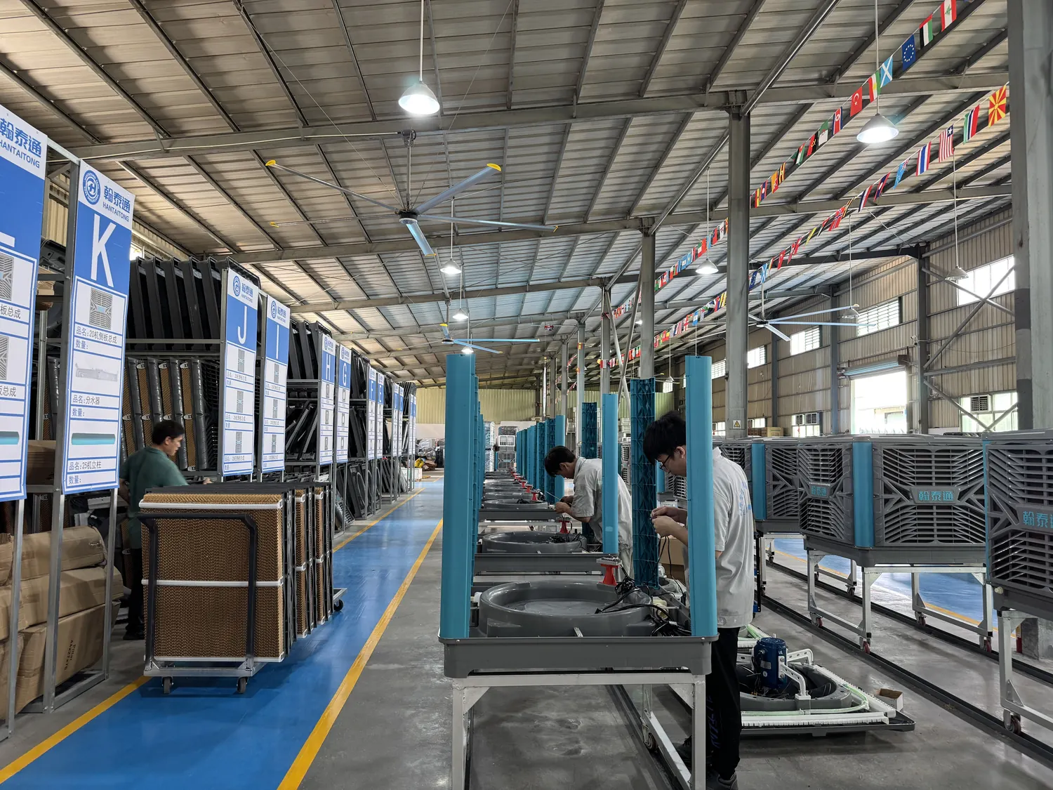 Workers fitting cooling pad sections on evaporative air cooler production line