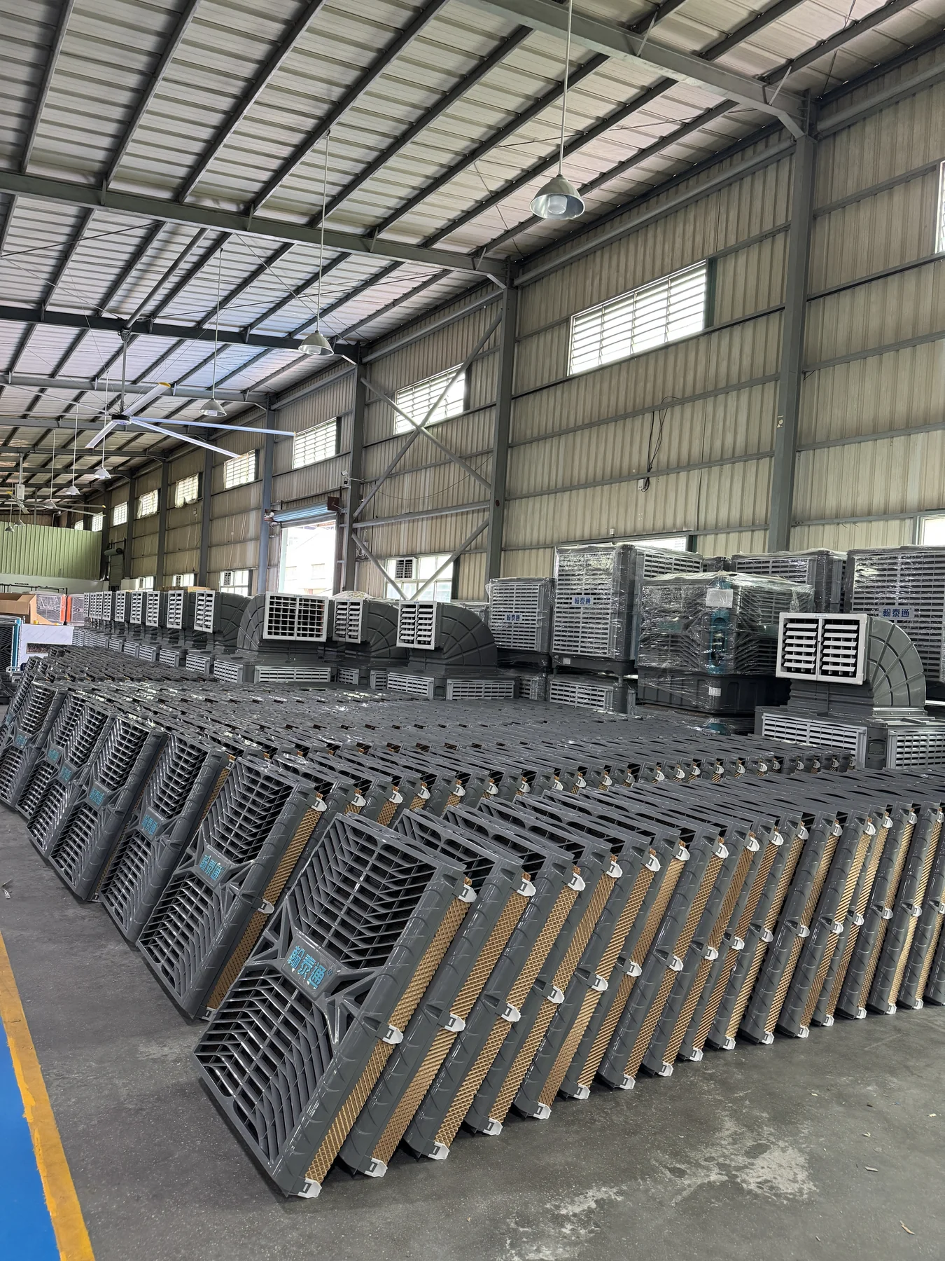 Evaporative air cooler cooling pad stock and finished units inside Hantaitong workshop