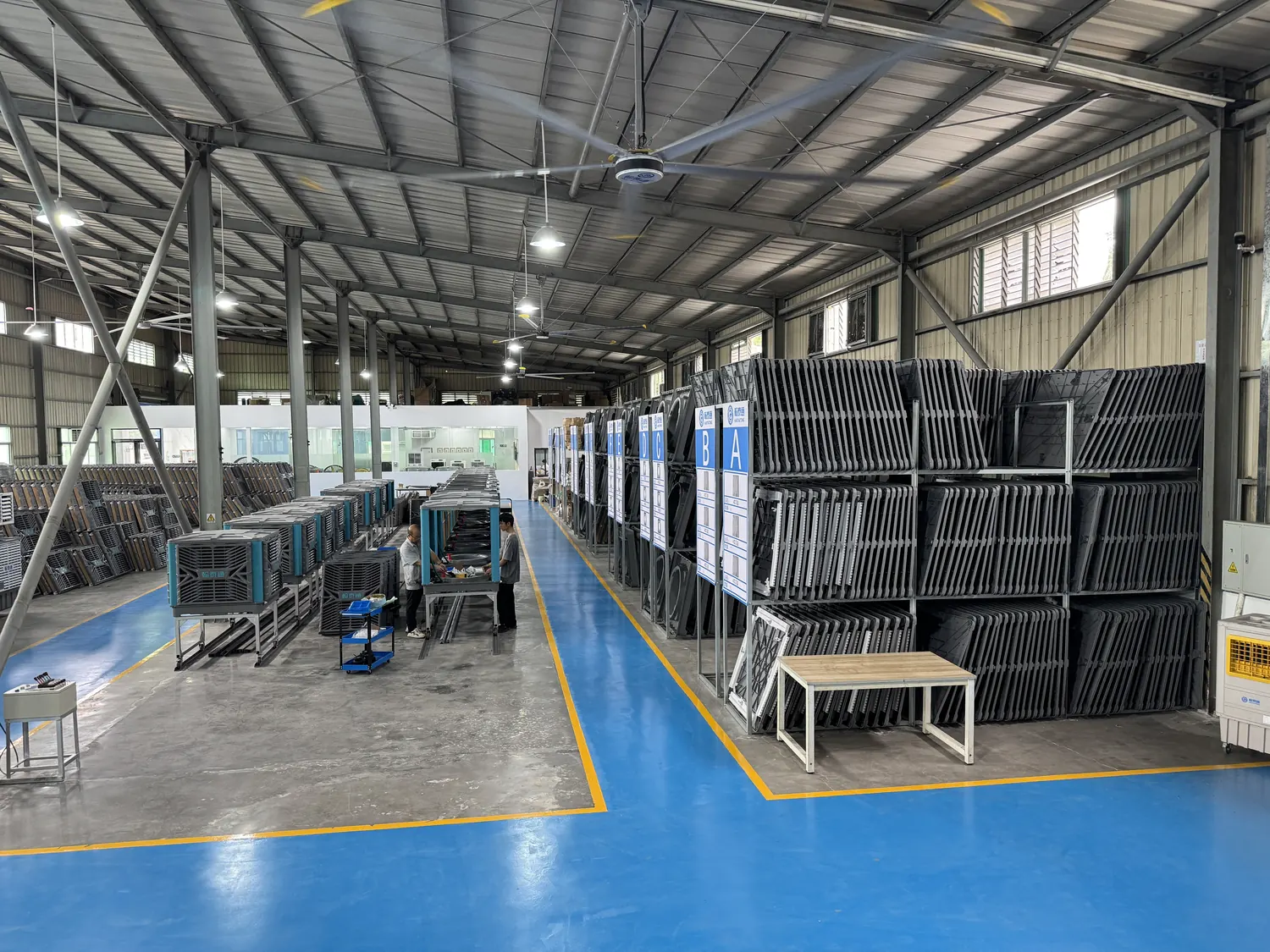Final assembly line with workers and evaporative air cooler cabinets