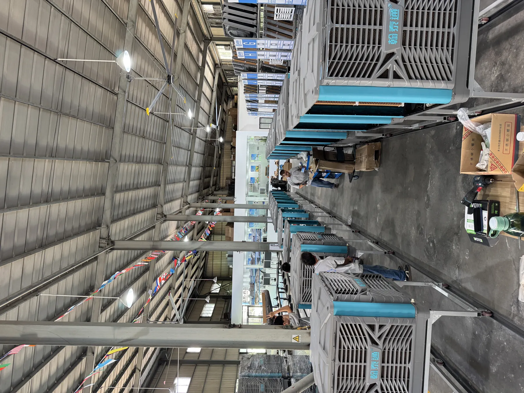 Evaporative air cooler units arranged on the production line