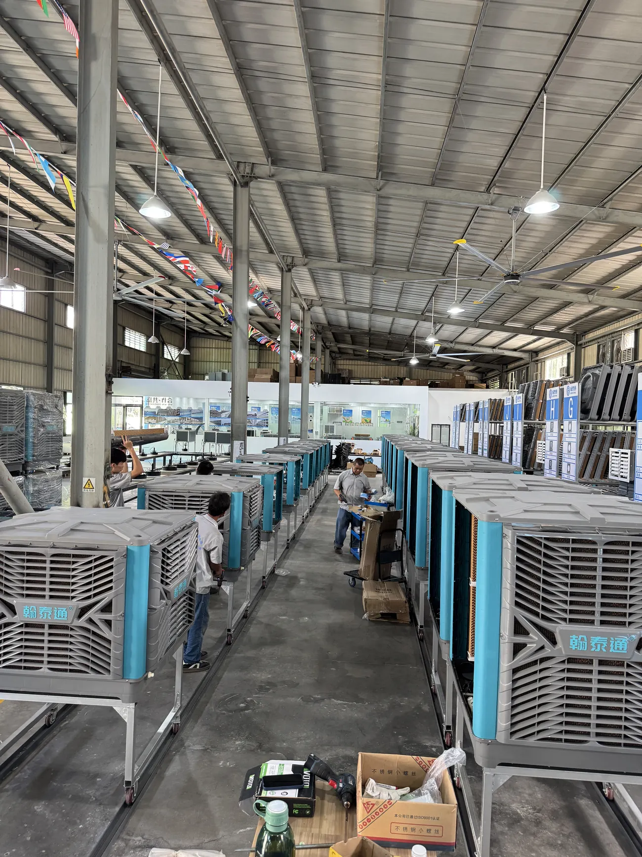 Workers assembling evaporative air coolers on the Hantaitong production line